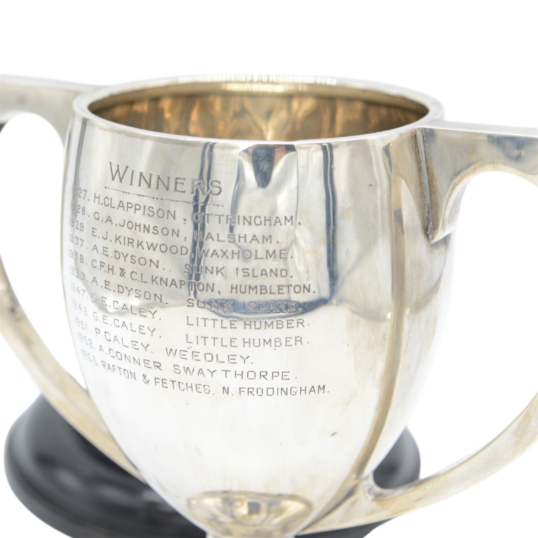 1920s silver twin handled trophy with engraving to body, upon circular foot and ebonised wooden plinth, total height H20cm
