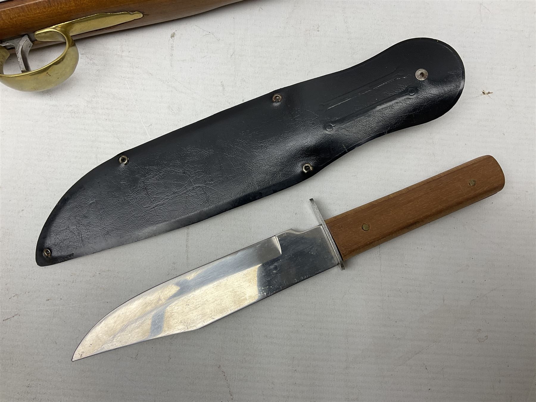 Reproduction non-firing flintlock pistol with brass skull crusher butt, the lock-plate inscribed 'Tower' and 'GR' L40cm; Sabre Japan Original Bowie Knife in sheath; and Indian embossed nickel two-piece walking cane (3)