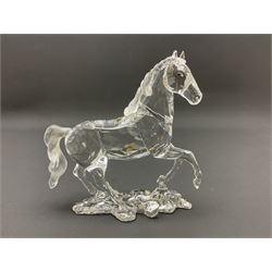 Five Swarovski Crystal horses, comprising stallion, rearing horse, pair of horses playing and Arabian stallion, each with frosted manes and tails, together with a small Swarovski Crystal galloping horse, the mane, tail and base with smoky tint