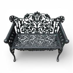 Coalbrookdale style - cast iron garden bench, with pierced foliate back, rams head arms, raised on cabriole legs, finished in green paint.