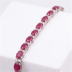18ct white gold ruby and diamond bracelet, twenty-six oval cut rubies, each spaced by two round brilliant cut diamonds, stamped 750, total ruby weight 12.70 carat, total diamond weight 0.46 carat