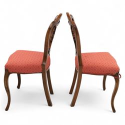 Set of four Victorian walnut balloon back chairs, with a carved and pierced back splat with foliate scrolls, serpentine seat upholstered in a diamond pattern fabric, raised on cabriole legs 