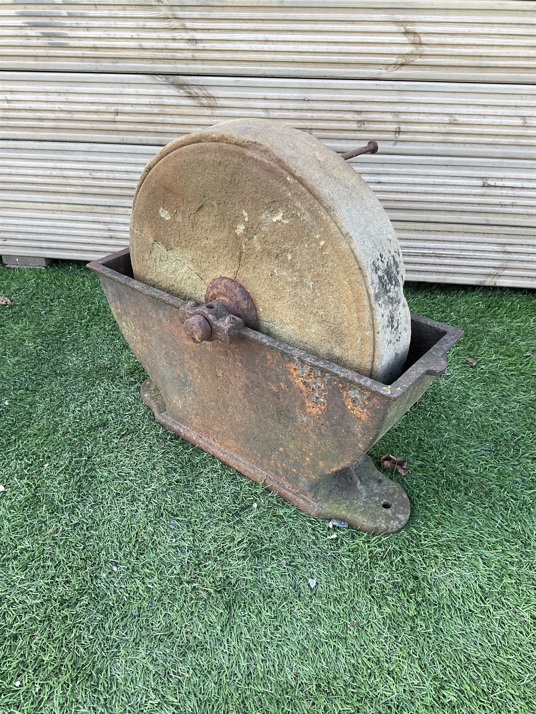 Small stone sharpening wheel, and a shallow cast iron trough - THIS LOT IS TO BE COLLECTED BY APPOINTMENT FROM DUGGLEBY STORAGE, GREAT HILL, EASTFIELD, SCARBOROUGH, YO11 3TX