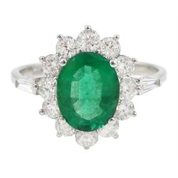 18ct white gold oval emerald and round brilliant cut diamond cluster ring, with tapering baguette cut diamond shoulders, stamped 750, emerald approx 1.50 carat, total diamond weight approx 0.90 carat