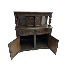 20th century oak court cupboard, arcade carved frieze over baluster supports with demi-hexagon cupboard with lozenge carved facias, the base fitted with two drawers over double cupboard, each with heavily moulded edges