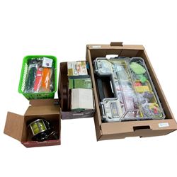Two boxes of assorted fly fishing flies together with can fishing rod and other fishing tackle