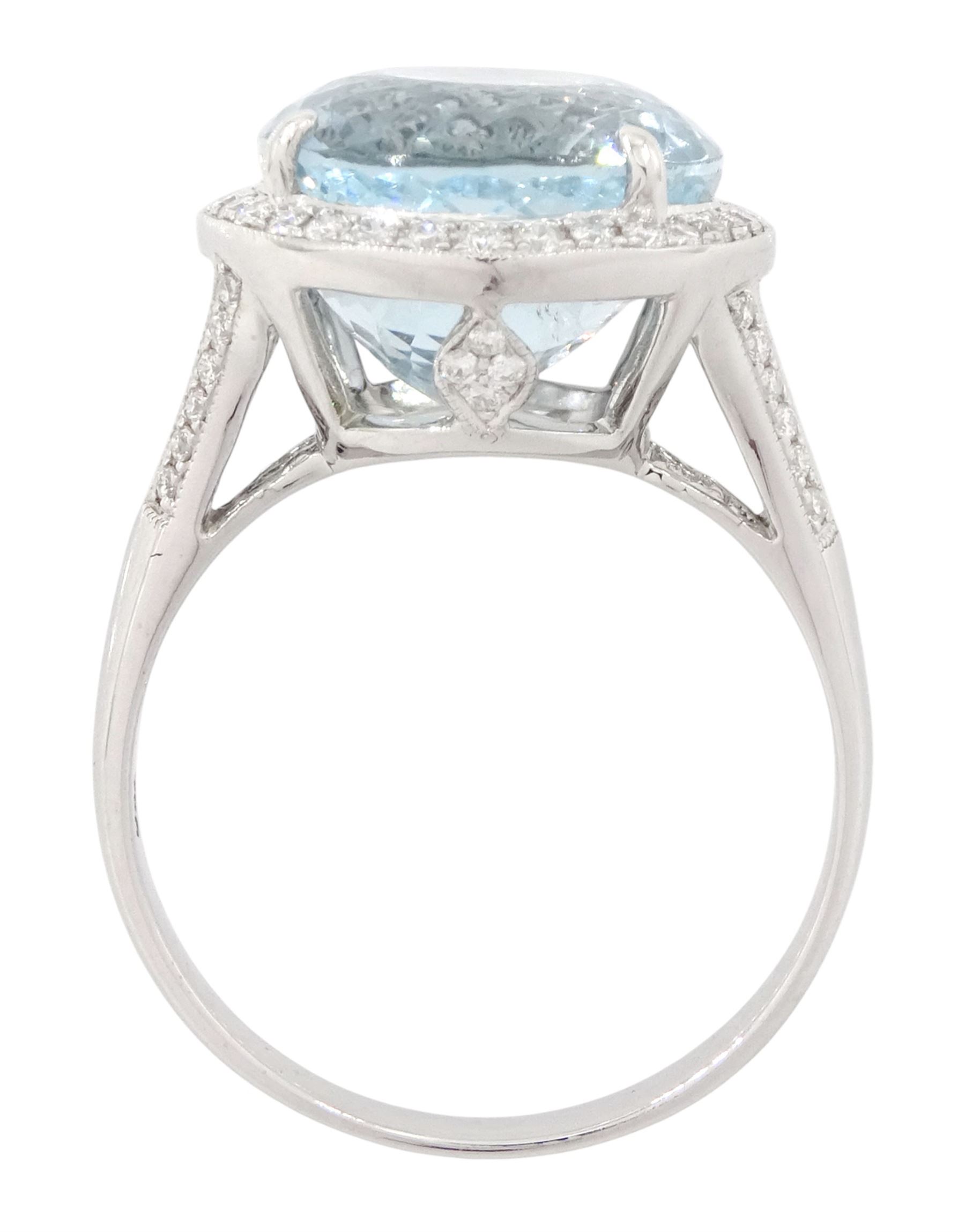 18ct white gold aquamarine and diamond cluster ring, single oval cut aquamarine of approx 8.20 carat, surrounded by milgrain set round brilliant cut diamonds, with diamond gallery and split diamond set shoulders, stamped 750, total diamond weight approx 0.30 carat