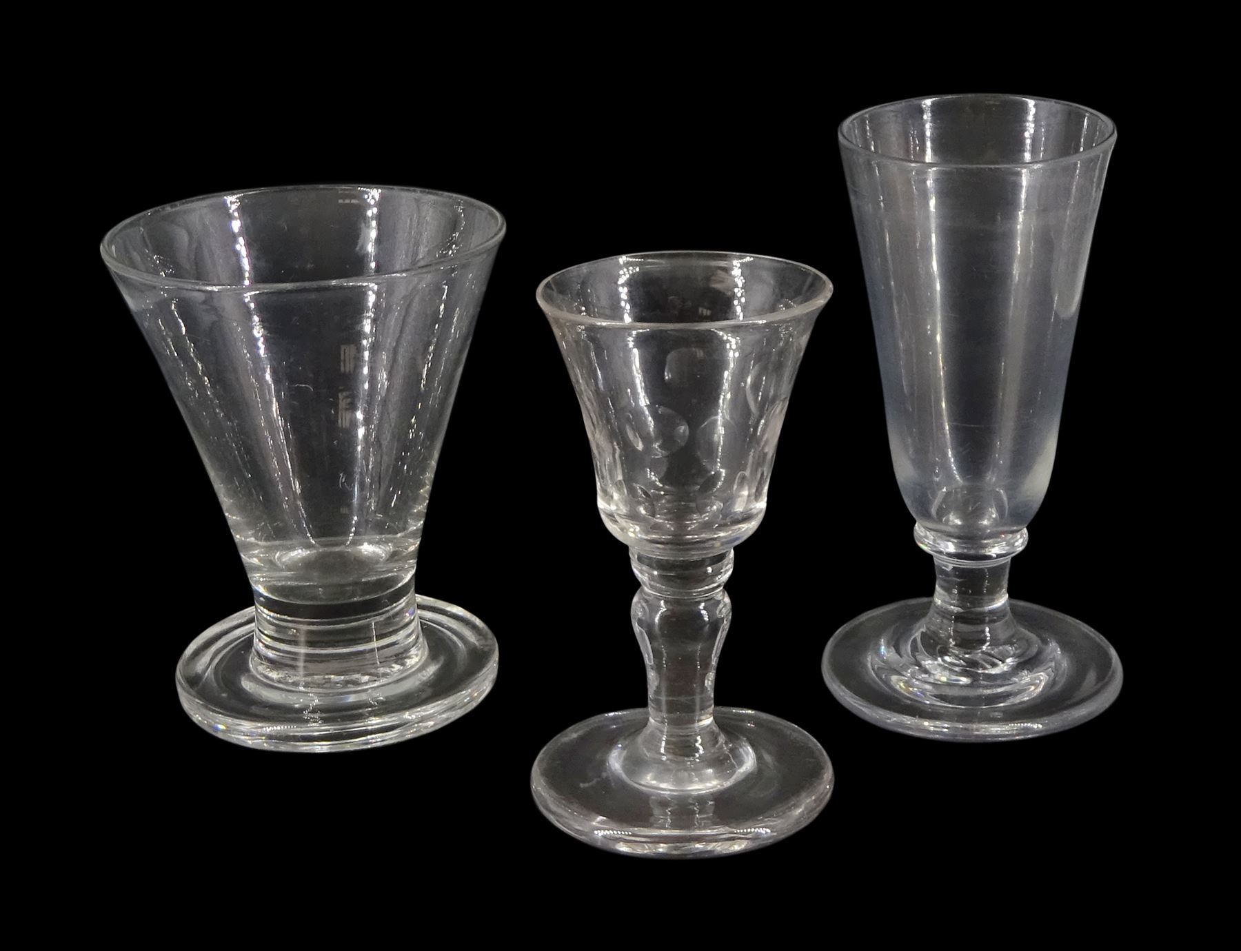 Large 19th century firing glass, the funnel bowl upon thick firing foot, H11cm, together with a further 19th century drinking glass, the funnel bowl cut with circles, upon a baluster stem and firing type foot, H11cm, and a 19th century dwarf ale glass upon a firing type foot, H13cm 