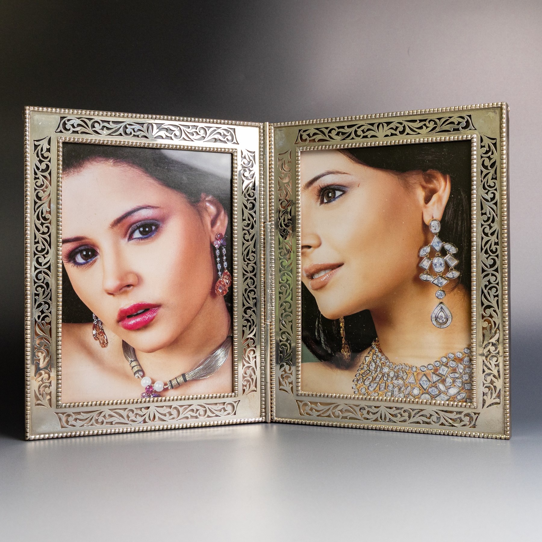 Indian silver folding double photograph frame, of rectangular form, with beaded border and pierced decoration, H22cm