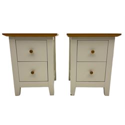 Pair of cream and oak bedside chests, fitted with two drawers