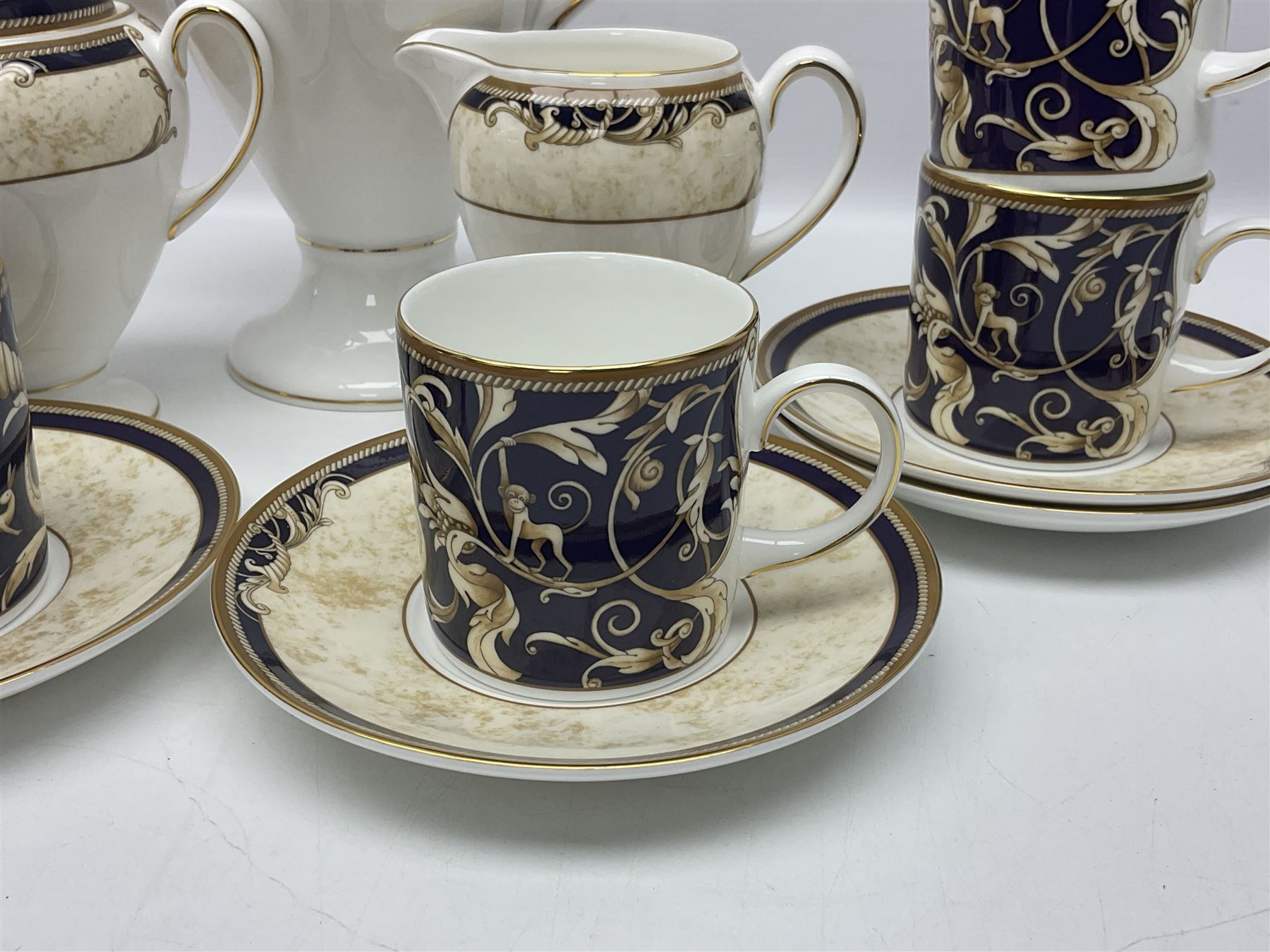 Wedgwood Cornucopia coffee service for six, comprising coffee pot, milk jug, twin handled covered sucrier, coffee cans and saucers