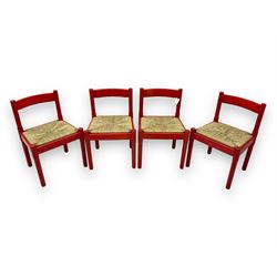 Vico Magistretti - mid-20th century circa. 1970s set of four beech framed dining chairs in red finish, with drop-in rush seats