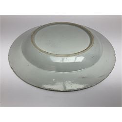 Three 18th century Chinese Famille Rose plates, the first example enamelled with blossoming peonies, rockwork and fence, the other two examples of similar design, decorated with blossoming peonies and sprigs within shaped inner borders, each approximately D23cm