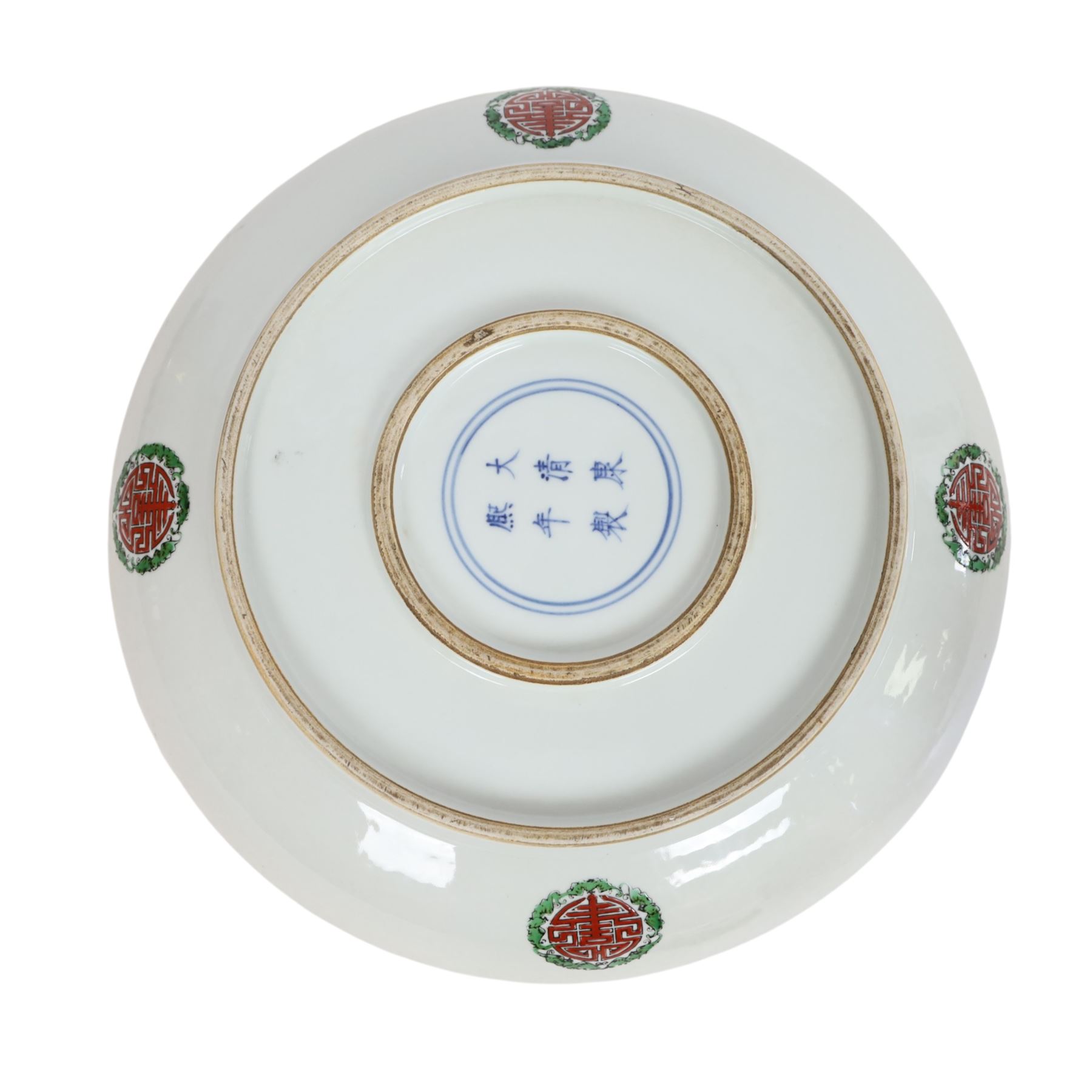 20th century Chinese charger, decorated in blue, green and red enamels with a four clawed dragon chasing the flaming pearl amidst waves and flower heads, the rim with border of alternating reserves of auspicious emblems and flower scrolls, bearing apocryphal Kangxi mark beneath, D38cm 

