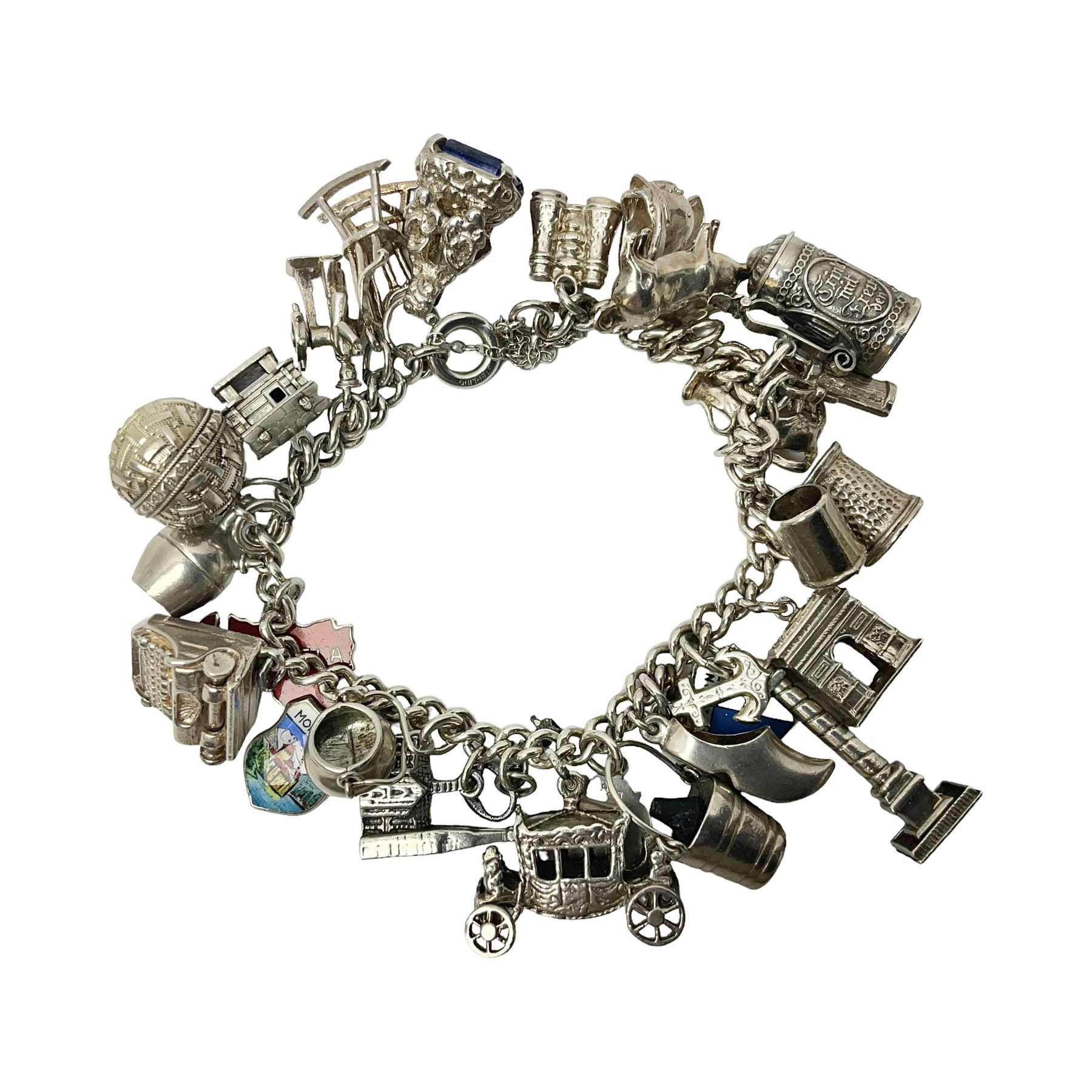Silver charm bracelet, with twenty eight charms, including typewriter, rocking chair, carriage, cauldron, etc