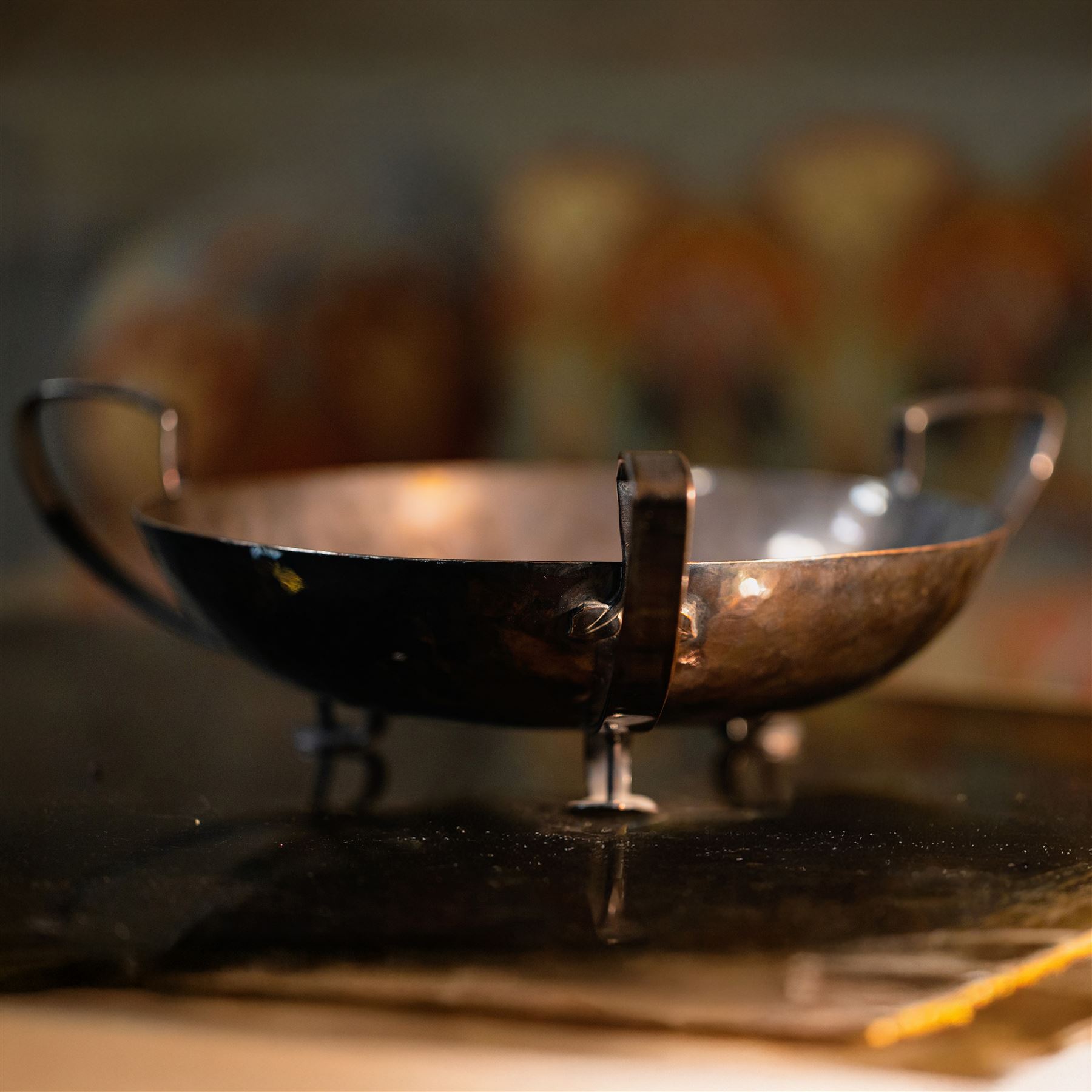 The Keswick School of Industrial Art, three stem bowl, the bowl supported upon three strapwork handles finished in leaf designs, marked beneath Keswick C196, H9cm D21cm
