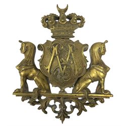 Brass Coat of Arms, the monogrammed shield with Egyptian style hounds with women's heads seated either side, surmounted by a crown, with scrolling foliate detailing, L19cm