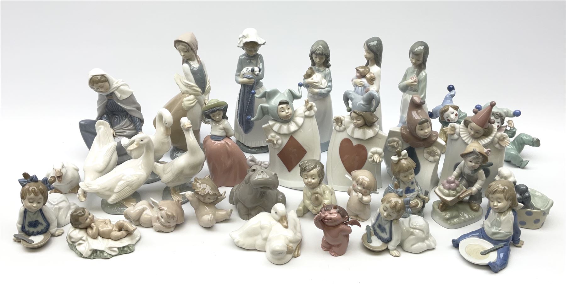 Collection of Nao figures, including four playing card jesters, two clowns, Virgin Mary and baby Jesus , five geese etc. 