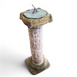 Weathered cast stone sundial, shaped top with metal dial, patterned column