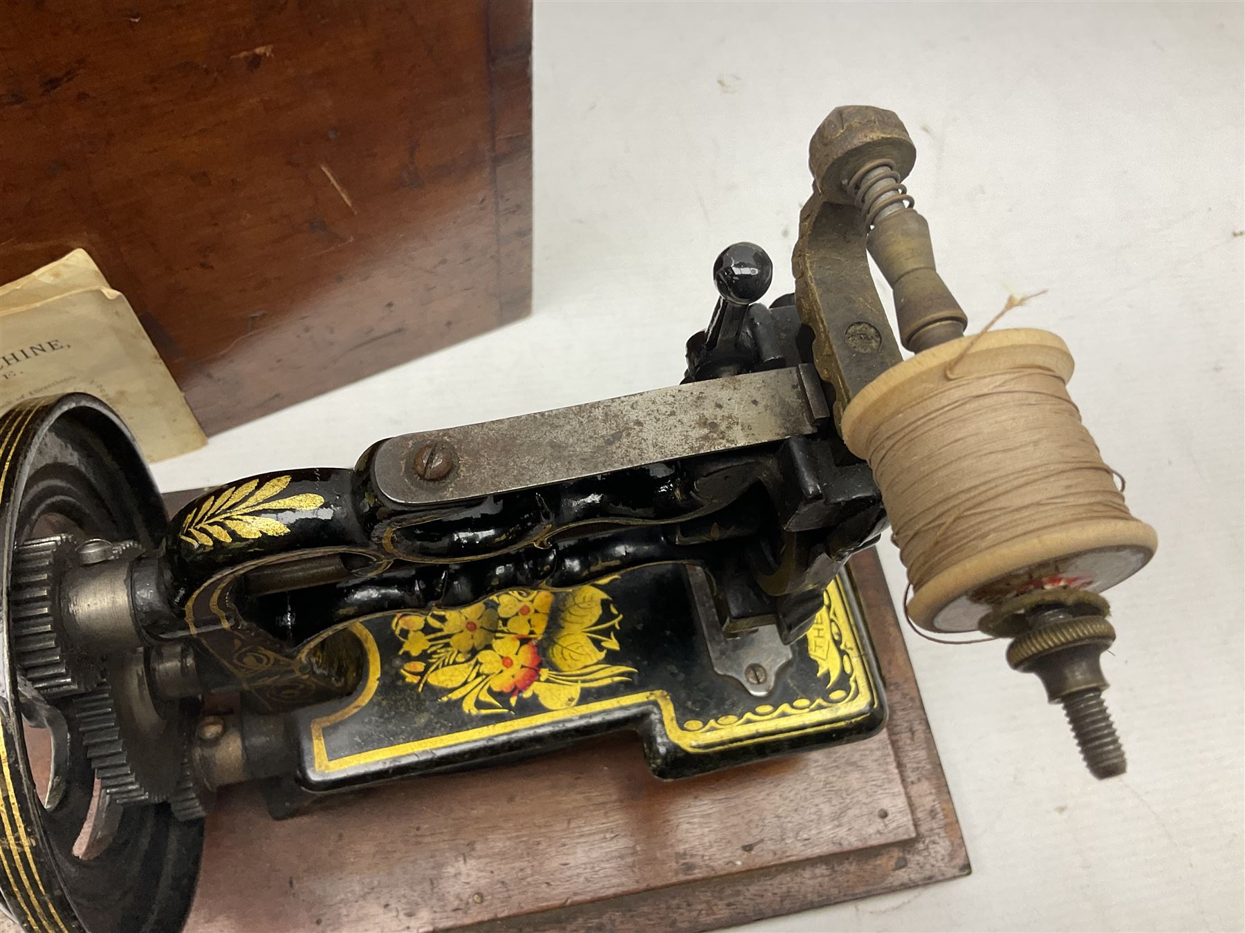 James G Weir 'The Globe' hand-cranked sewing machine, circa 1872, in black finish with gilt and flower painted decoration, the bed stamped Ja's G. Weir, 2 Carlisle Street, Soho Sq., London, with walnut locking carrying case and original manual, boxed H25cm 