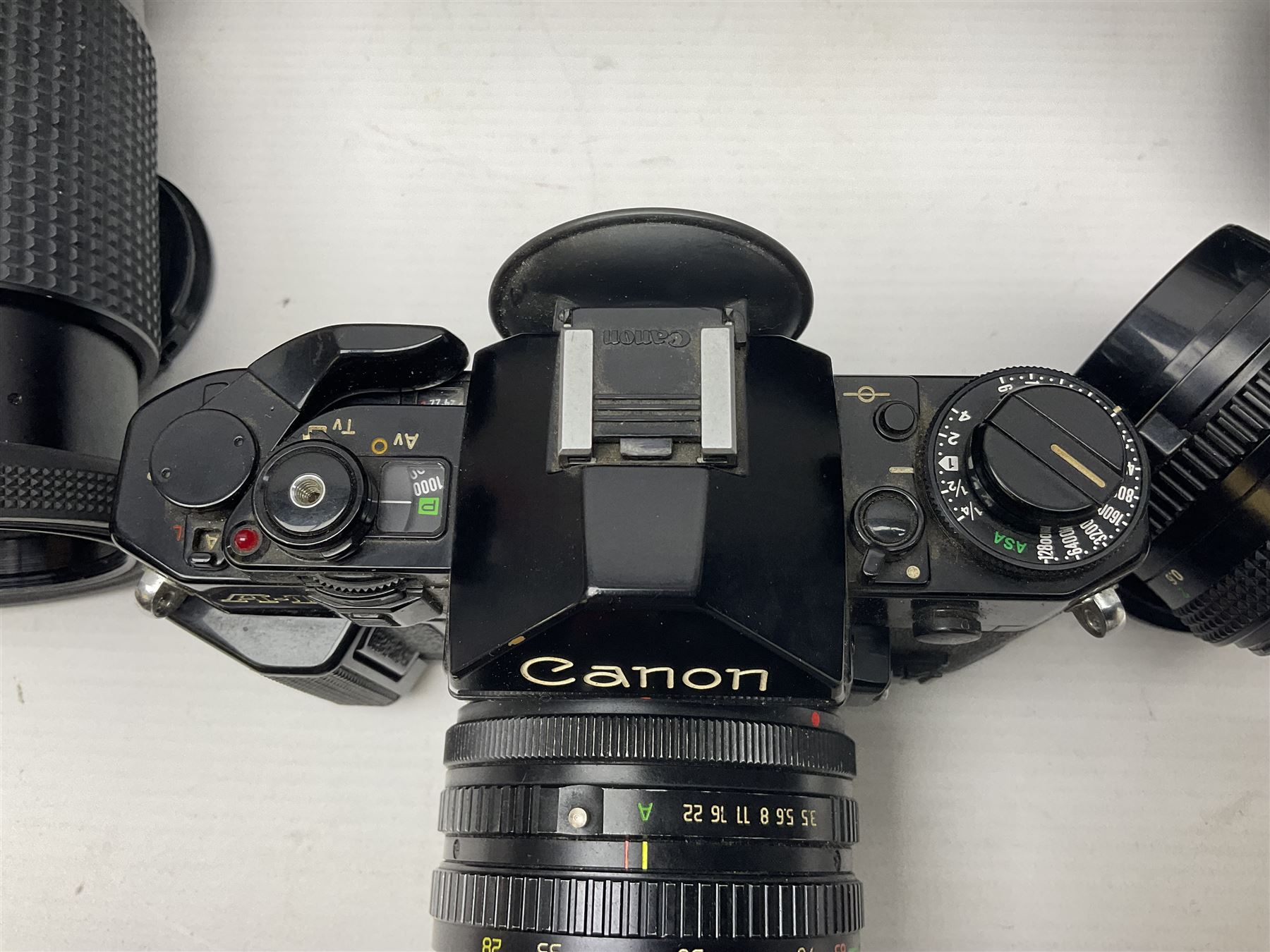 Canon A1 35mm camera body serial no 741264, with 'Tokina AT-X 28-85mm 1:3.5-4.5' lens serial no 821679, 'Canon FD 50mm 1:1.8mm' lens and other camera equipment 