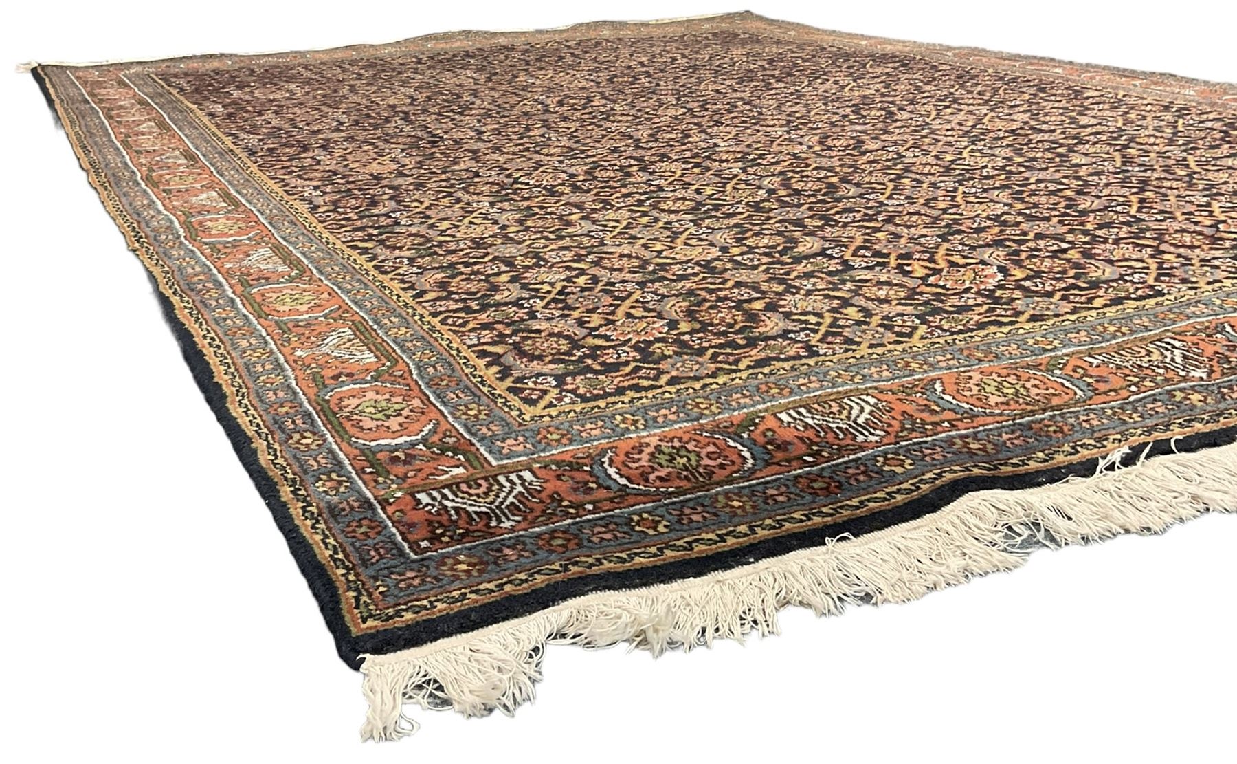 Persian Herati indigo ground rug, the field decorated with repeating Herati motifs, floral design border within guard stripes 