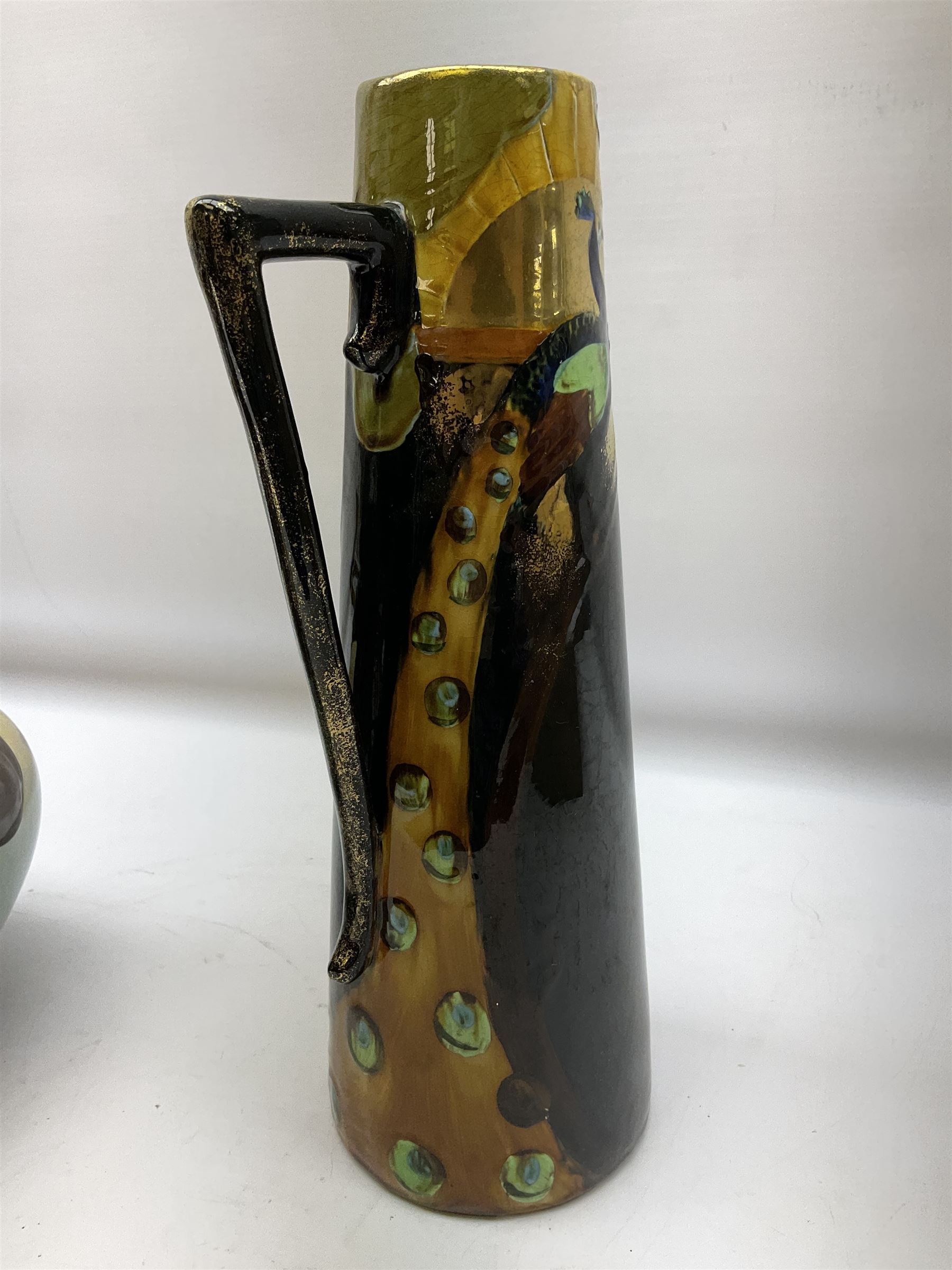 T. Forester Phoenix ware ewer of tapering form decorated with peacock and Bretby twin handled vase decorated with figures fishing in a boat sea scene