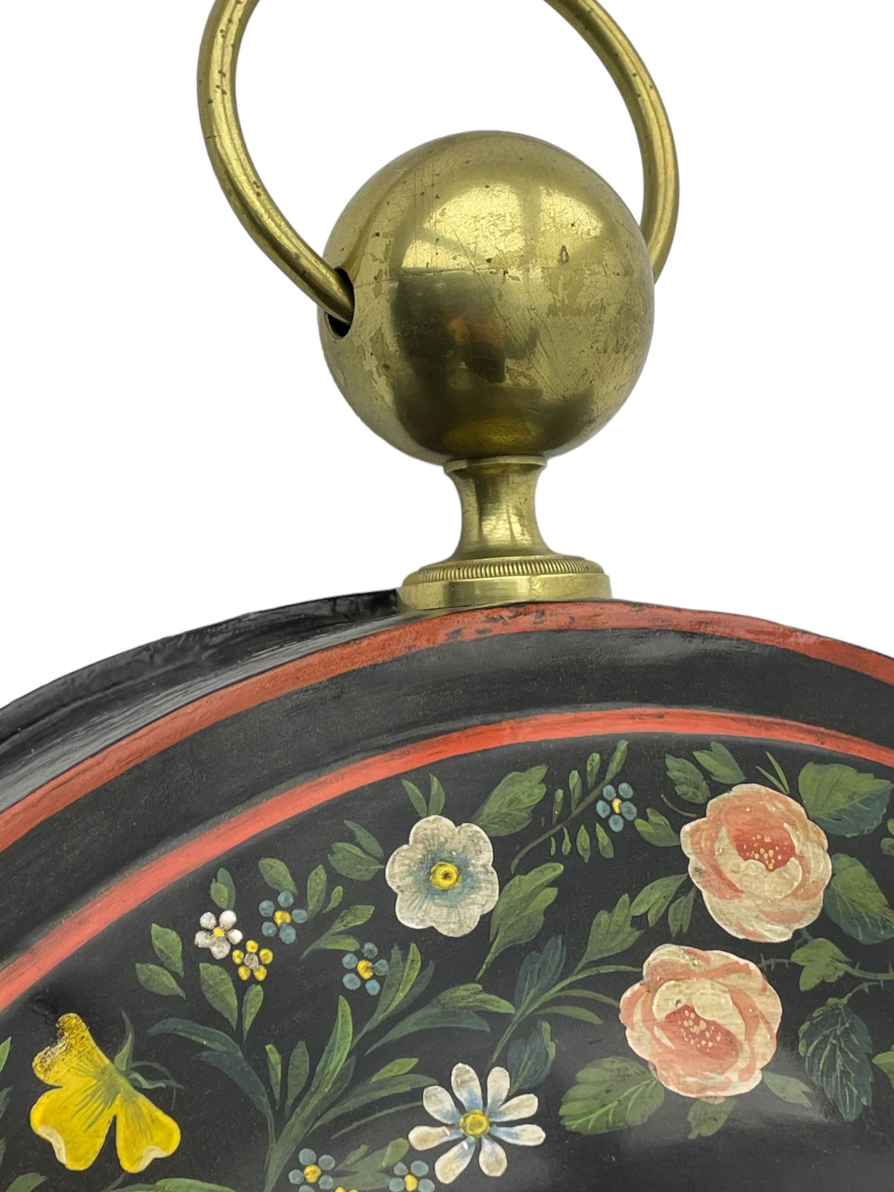 Honore Pons of Paris -  A good and early 19th century Tole Ware wall clock c1830, with a later re-decorated case suspended from a circular brass hanger, cast brass dial bezel and silvered engine turned dial with roman numerals, minute track and steel moon hands, 8-day twin train countwheel striking movement with a silk suspension, striking the hours and half hours on a bell. With pendulum and key.
