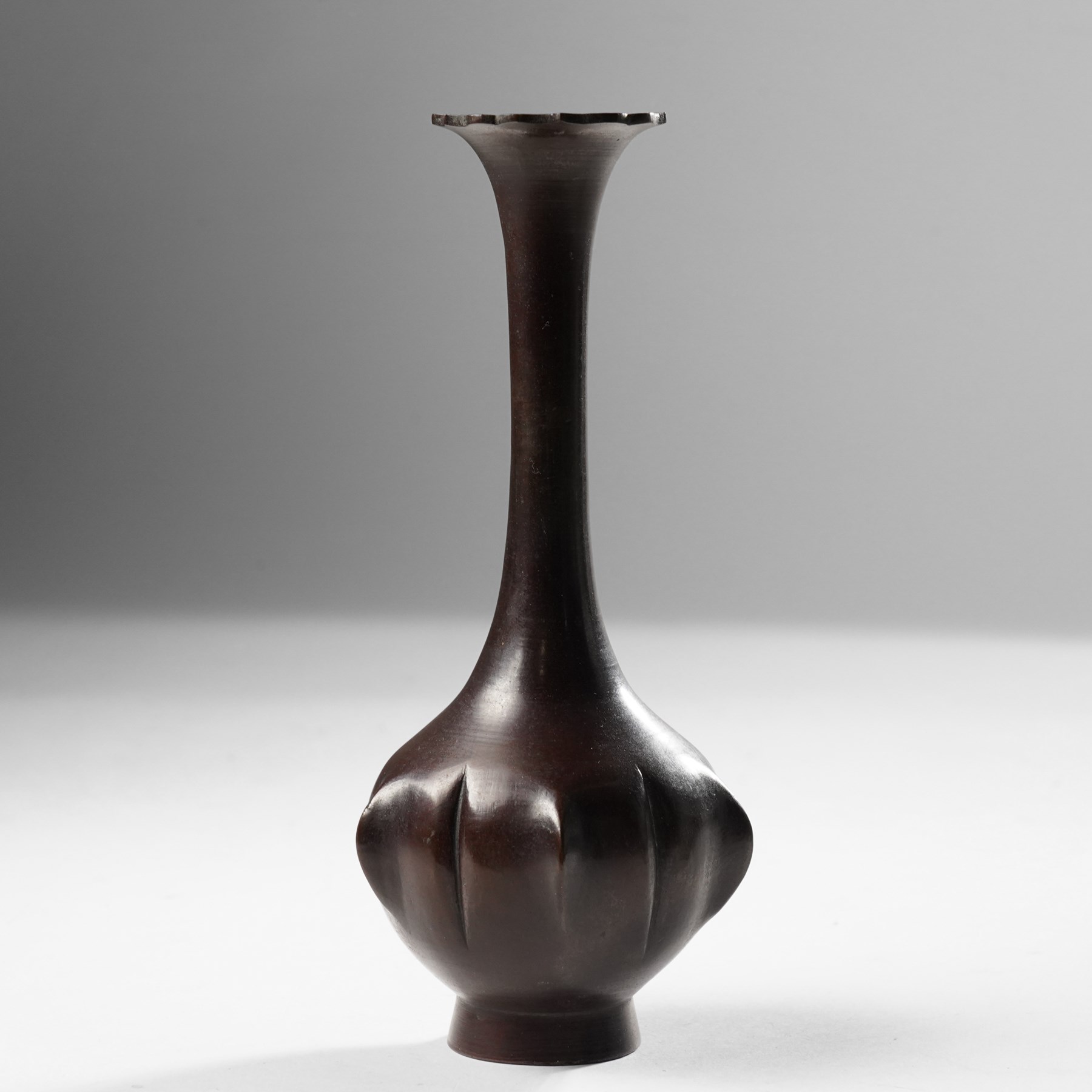 Japanese red patinated bronze bottle vase, the base with naturalistic lobed decoration, unmarked, H19cm 