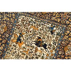 Persian pictorial rug featuring a hunting scene, ivory field with mounted hunters, animals, birds and trees, rich navy and terracotta floral border with rosettes and palmettes 