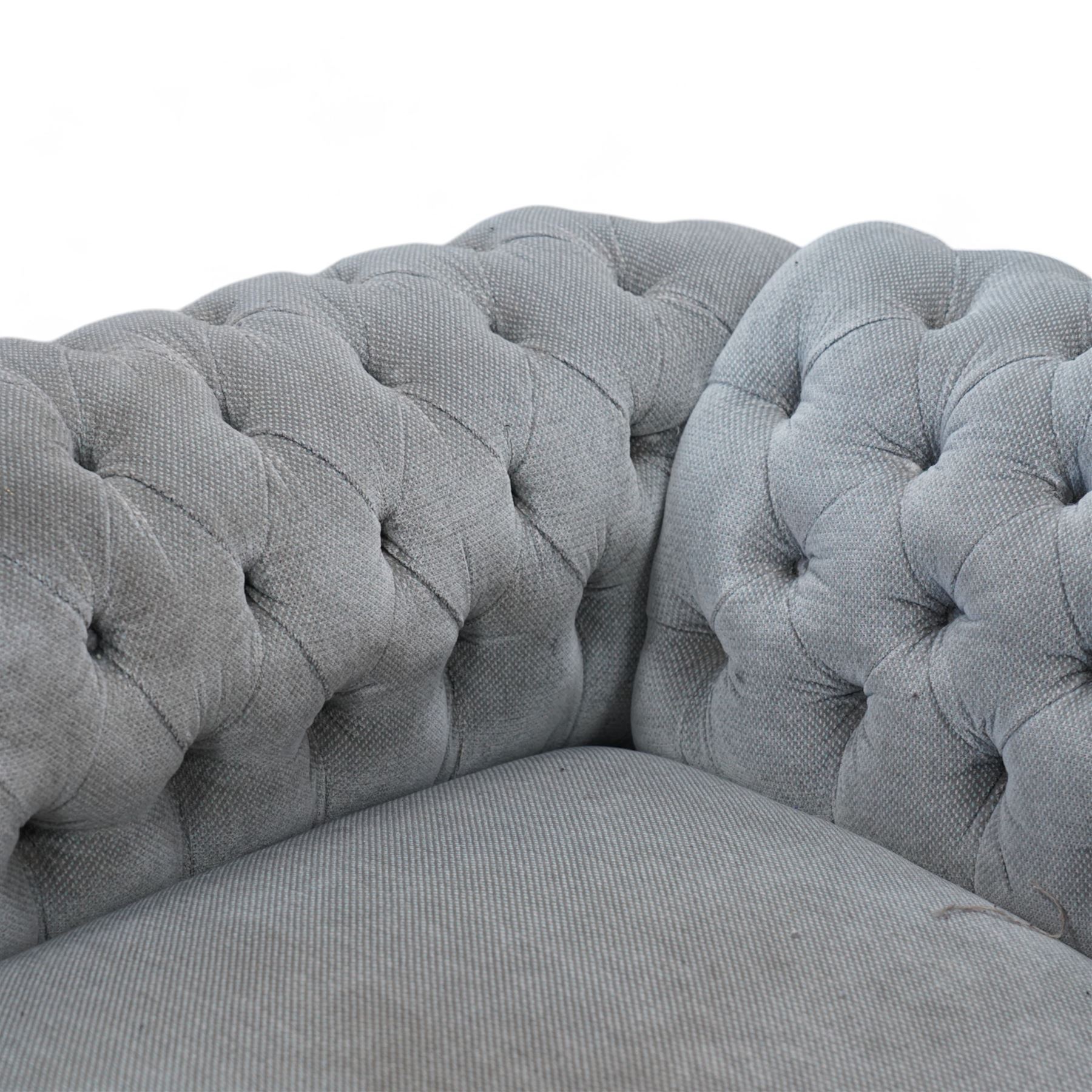 Early 20th century Chesterfield drop-arm two-seat settee, traditional shape with rolled arms and back, upholstered in buttoned pale blue fabric, on ogee block feet with brass castors 