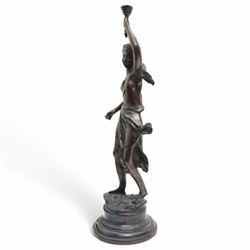 After Victor Rousseau (1865-1954)  - bronze sculpture of a lady holding aloft a torch and on circular base H50cm