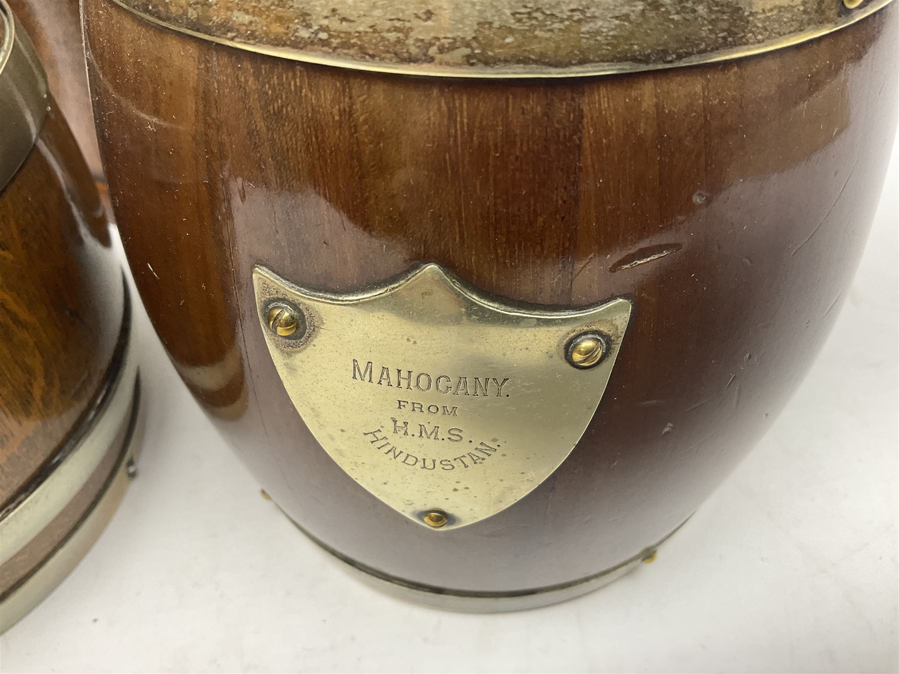 Five early 20th century biscuit barrels with silver-plated mounts, one made from Mahogany from HMS Hindustan