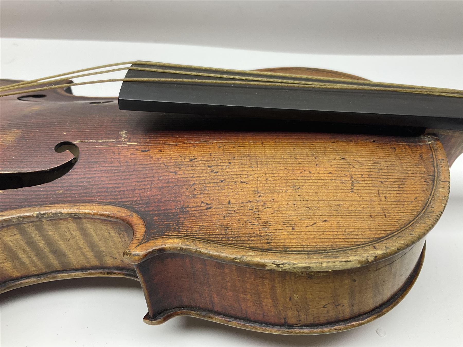 Late 19th century French three-quarter size 'Conservatory' violin with 34cm two-piece maple back and ribs and spruce top, the peg box inscribed 'Conservatory Violin Straduari', bears label 'Antonius Stradiuarius Cremonensis Faciebat Anno 1721' L55.5cm overall; in ebonised wooden 'coffin' case; and Saxony violin c1900 with 36cm two-piece maple back and ribs and spruce top; bears label 'Antonius Stradivarius Cremonensis Faciebat Anno 17**' L59cm overall; in carrying case (2)