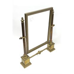 A brass table top swing mirror, upon stepped supports with stretcher, H41.4cm L34.5cm.