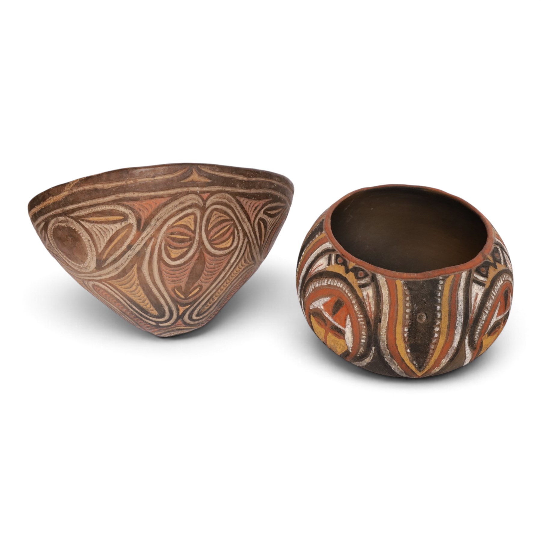 Two terracotta clay cooking pot, decorated with faces in neutral tones, together with three similar pots