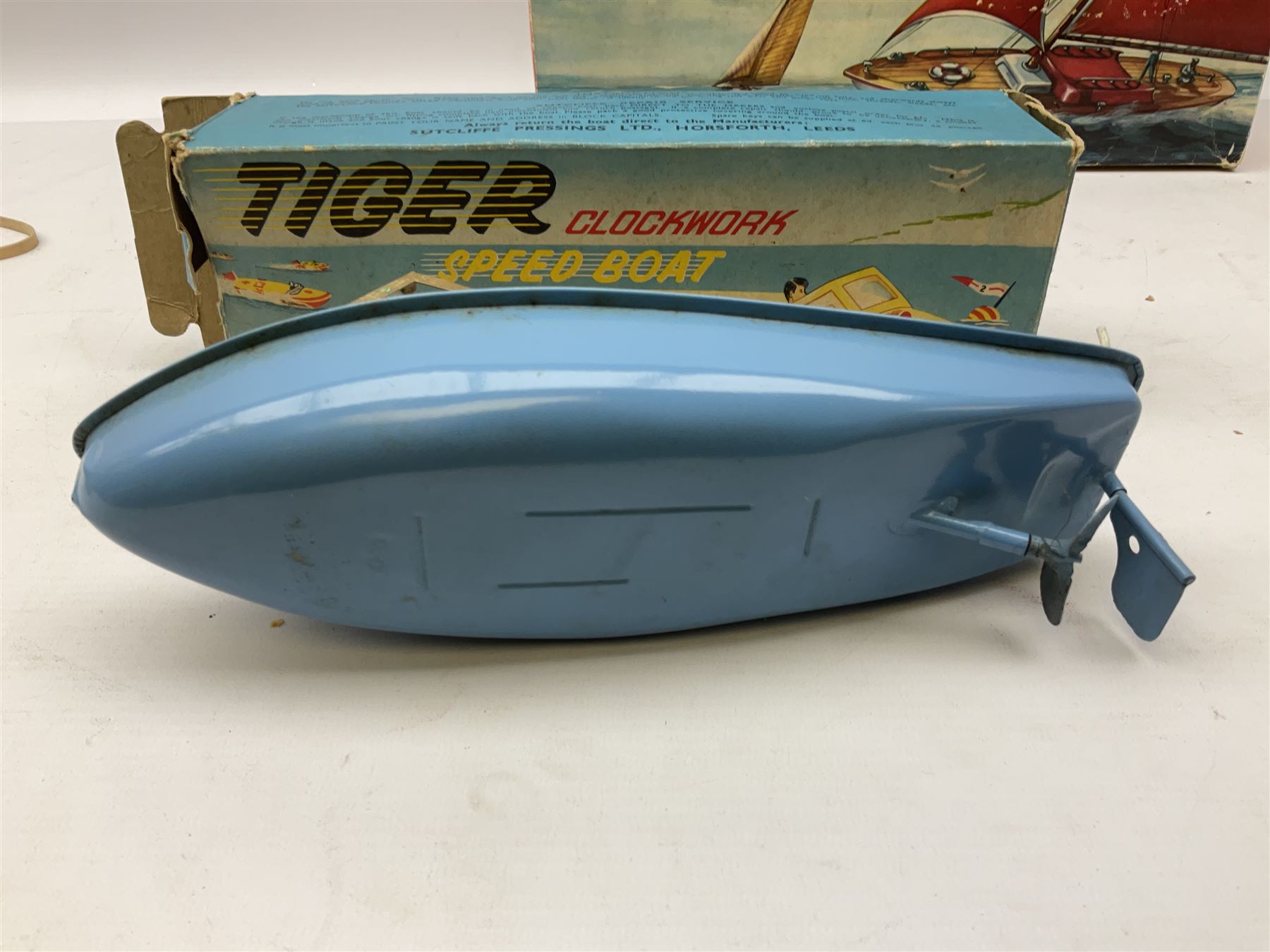 Five model boats - Sutcliffe clockwork Tiger Speedboat; boxed; Motor Sailor battery operated yacht; boxed; Waterline battery operated police launch; boxed; and Tri-ang Scalex 'Aberdeen' North Sea Drifter; boxed, with another similar unboxed (5)