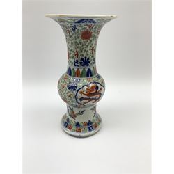19th century Chinese vase, of gu form, decorated in the Wucai palette with two central panels containing five clawed dragons in blue and red, with foliate tendril surround, and lower border of birds upon blossoming branches, with six character underglaze blue Wanli mark within double concentric circle beneath, H23cm