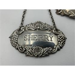 Five modern silver decanter labels, to include two sherry examples, embossed with scrolls and fruits, hallmarked W I Broadway & Co, Birmingham 1991 & 1997, a similar claret example, hallmarked S J Rose & Son, Birmingham 1973, and two plain shaped port and burgundy examples, hallmarked C Robathan & Son, Birmingham 1997 and A Haviland-Nye, London 1968