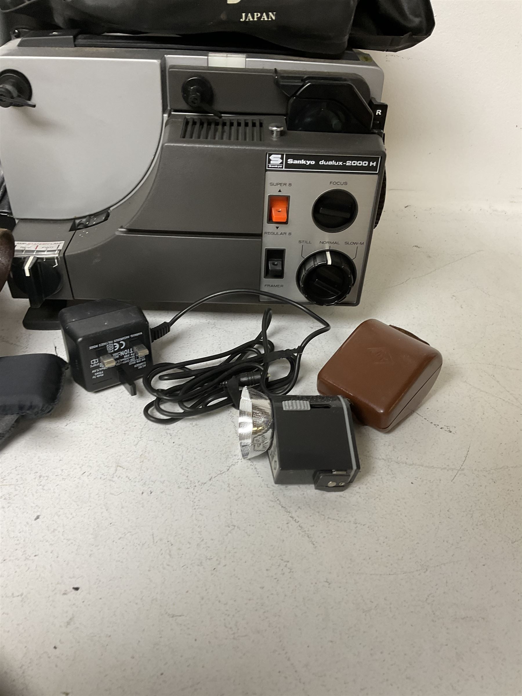 Sankyo Dualux-2000H projector, with cover, together with two vintage camera cases, etc