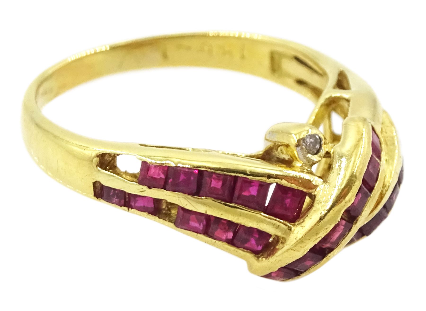 18ct gold channel set, calibre cut ruby and round brilliant cut diamond crossover ring, stamped 750