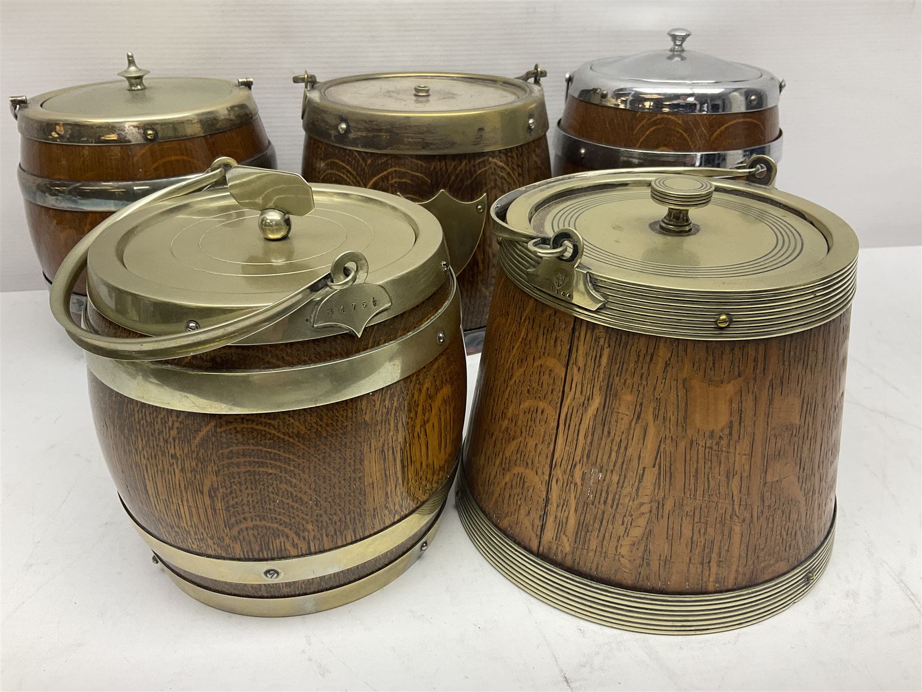Five early 20th century biscuit barrels with silver-plated mounts