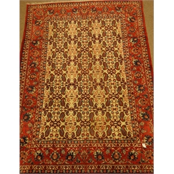 Persian red and beige ground rug, decorated with Herati and Boteh motifs, 310cm x 215cm