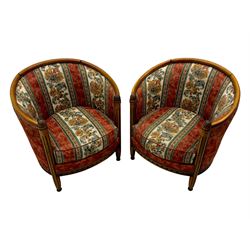 Pair of cherry wood framed tub-shaped armchairs, upholstered in striped floral fabric with brass stud trim, carved walnut frame with fluted supports capped with pinecone finials, on turned feet