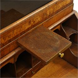 Quality George I figured and burr walnut bureau-cabinet of unusually small proportions, the projecting cavetto cornice over a glazed and banded door enclosing four adjustable shelves, with a candle slide below, the book-matched and banded veneer fall-front enclosing a fitted interior with pigeonholes, correspondence drawers and original trinket boxes and inkwells, over two pull-out stays and four graduating long drawers with banded facias and pressed brass escutcheons and pull handles, lower moulded edge on bracket feet
Provenance: purchased Sotherby's 1977