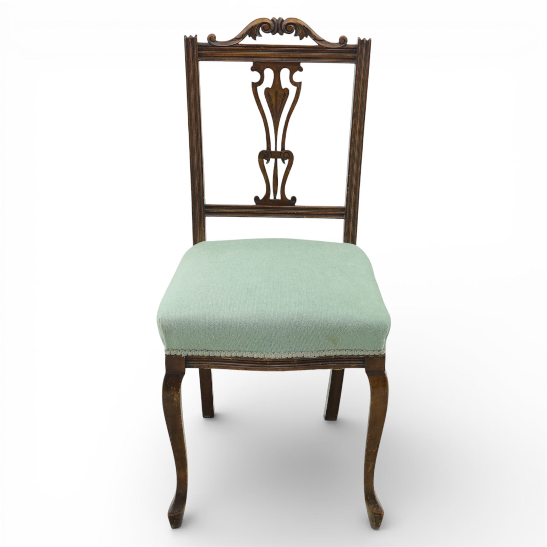 Late Victorian mahogany side chair, the carved cresting rail above a pierced and carved splat with lyre-form detail, the back panel inset with cane work, drop-in upholstered seat in pale green fabric with braid trim, raised on cabriole supports