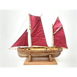 A wooden model of a twin masted fishing yawl, on stand, L60cm.   