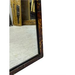 Early 20th century wall hanging tortoise shell framed mirror, of rectangular form, the upper half of the frame shaped and stepped surrounding a plain mirror plate