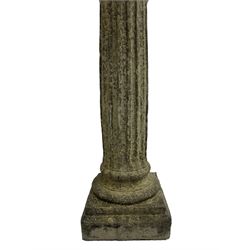 Classical design cast stone female bust depicting Artemis, raised on fluted Corinthian column with acanthus leaf capital, stepped square base, looking right 