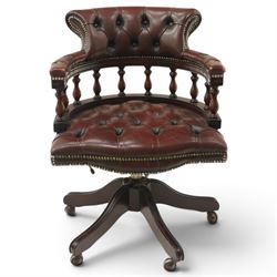 Georgian design captains swivel desk chair, rolled cresting rail over open spindle back on tripod base, upholstered in buttoned oxblood leather